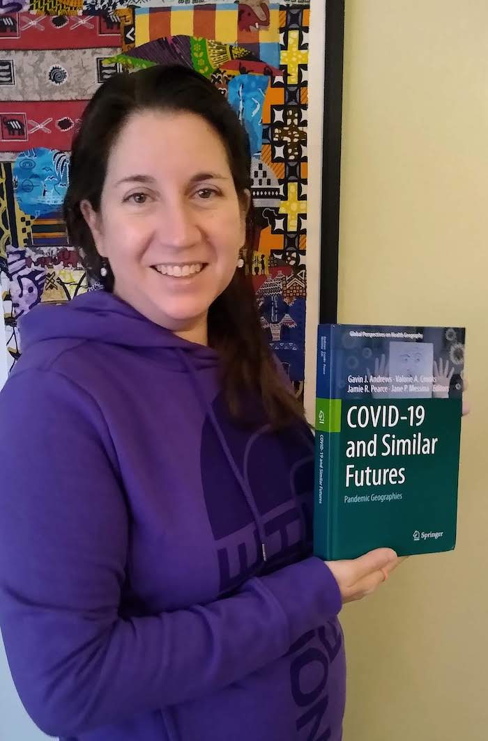 Dr. Ryan holds a copy of the book containing her published chapter.